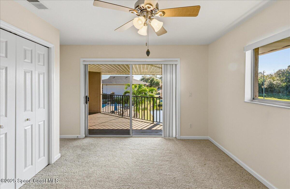 4129 Bond Avenue Rockledge, FL 32955 - Photo 26 of 45 a view of a room with a chandelier fan and windows