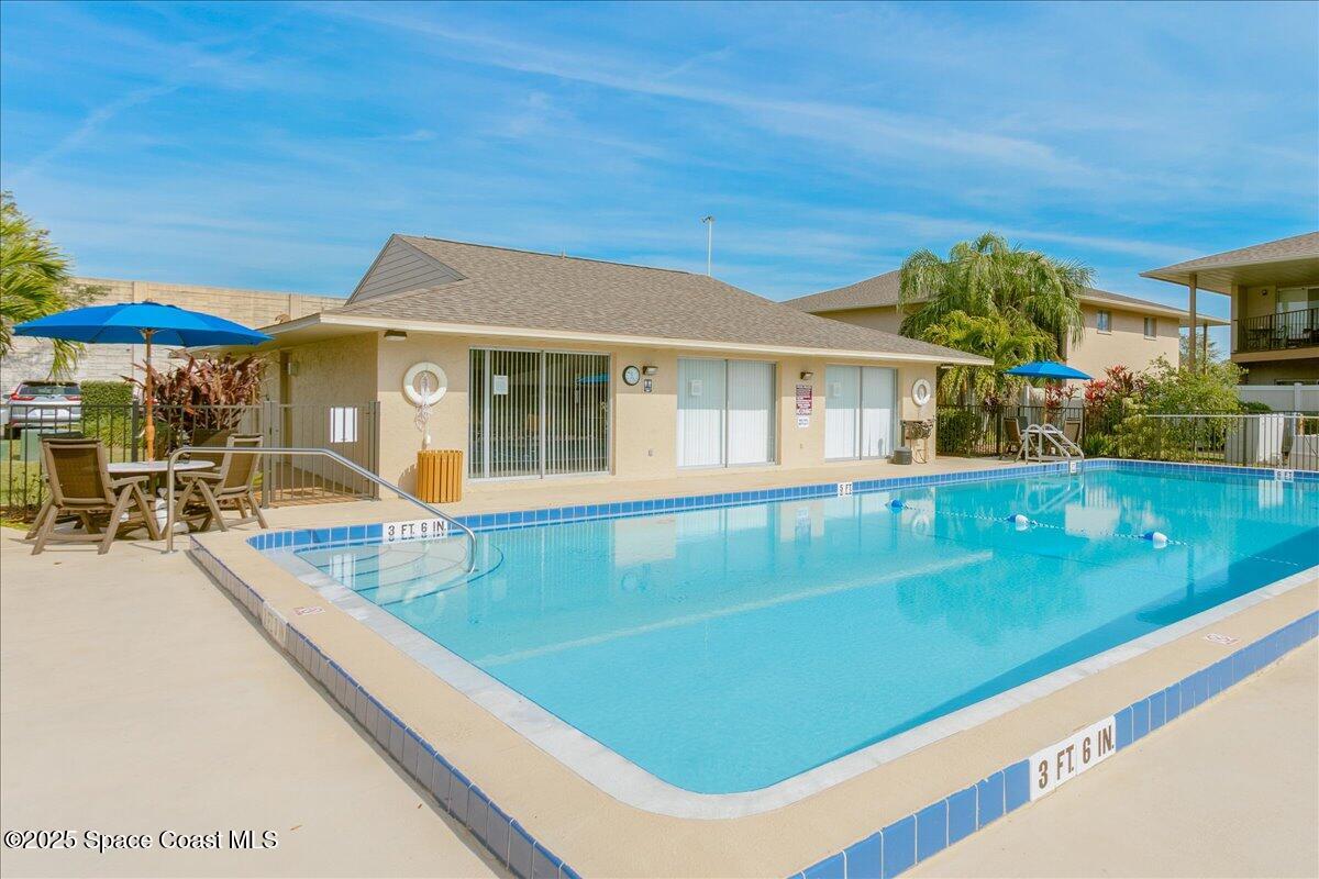 4129 Bond Avenue Rockledge, FL 32955 - Photo 35 of 45 a view of a patio with table and chairs under an umbrella