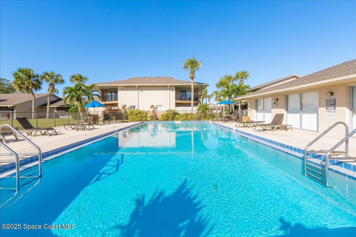 4129 Bond Avenue Rockledge, FL 32955 - Photo 39 of 45 a swimming pool view with a seating space and a garden view