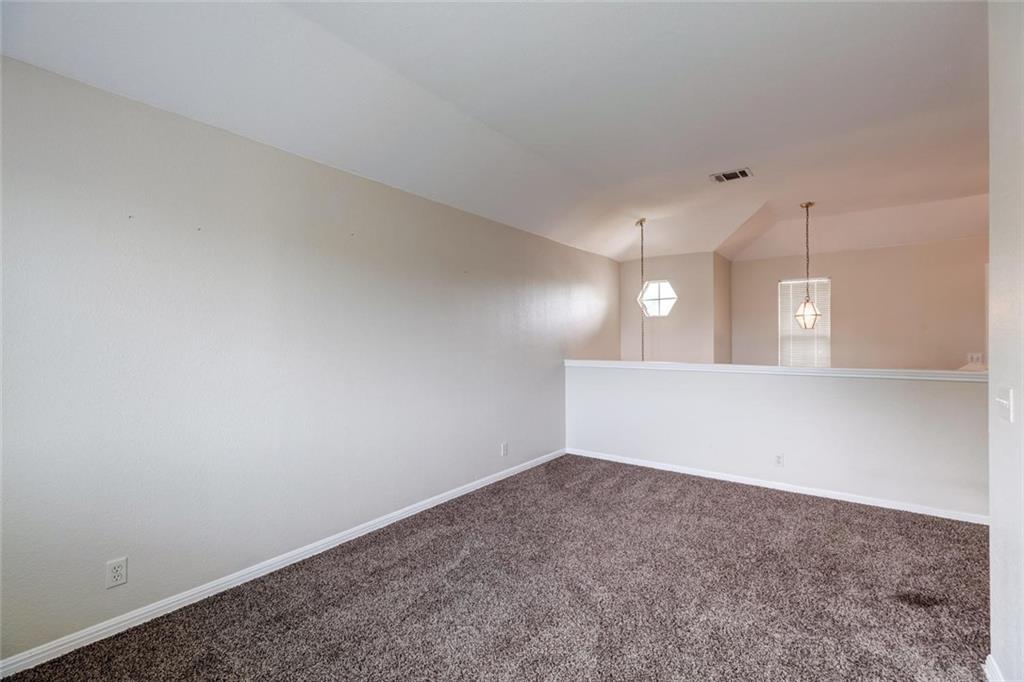 16712 Hamilton Point Circle Manor, TX 78653 - Photo 17 of 38 A versatile upper-level loft features wall-to-wall carpeting and views overlooking the living spaces below.