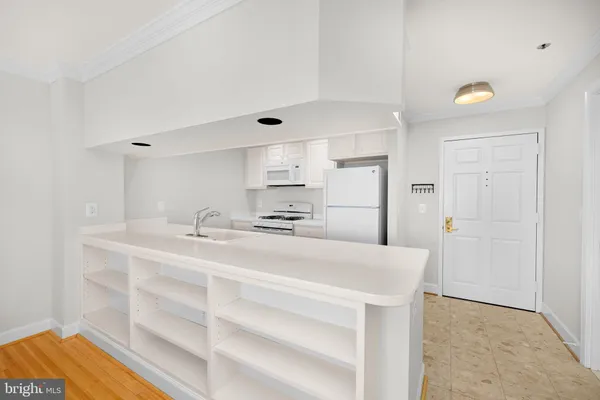 a view of kitchen with wooden floor and electronic appliances