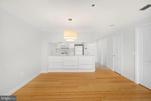 a view of a bedroom with a bed and a window
