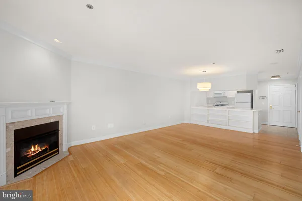 a view of an empty room with a fireplace and a fireplace