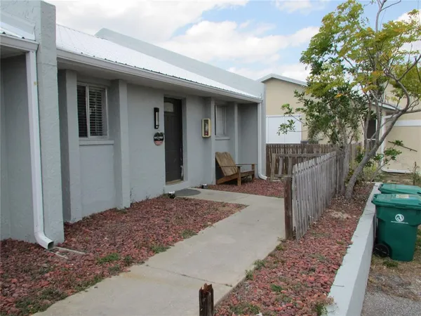 a view of a house with wooden fence