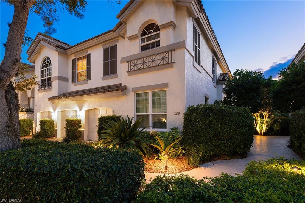 129 Colonade Circle, Unit 402 Naples, FL 34103 - Photo 1 of 36 a front view of a house with a yard