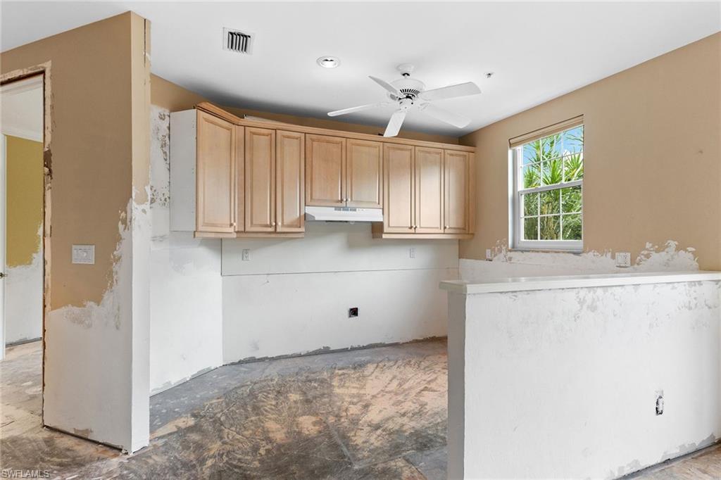 129 Colonade Circle, Unit 402 Naples, FL 34103 - Photo 14 of 36 a view of a kitchen with wooden floor