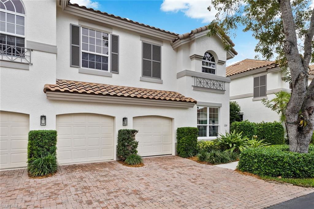 129 Colonade Circle, Unit 402 Naples, FL 34103 - Photo 28 of 36 a front view of a house with garden