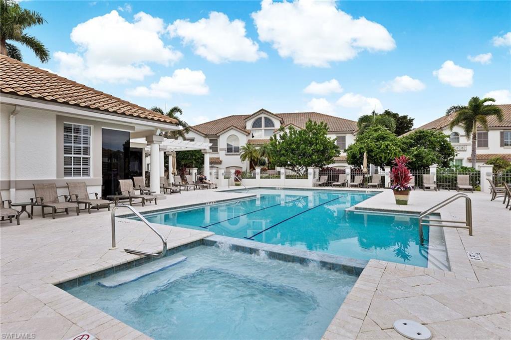 129 Colonade Circle, Unit 402 Naples, FL 34103 - Photo 31 of 36 a view of a patio with swimming pool table and chairs