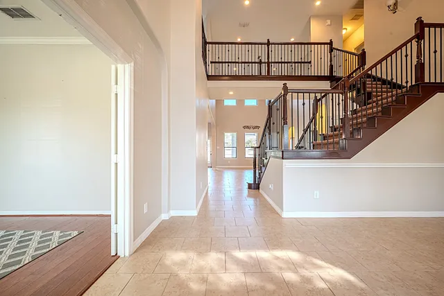 a view of entryway and hall with wooden floor