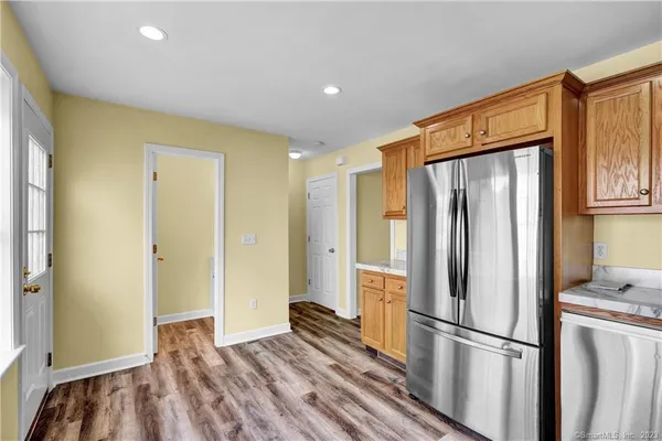 a kitchen with stainless steel appliances granite countertop a refrigerator and a refrigerator