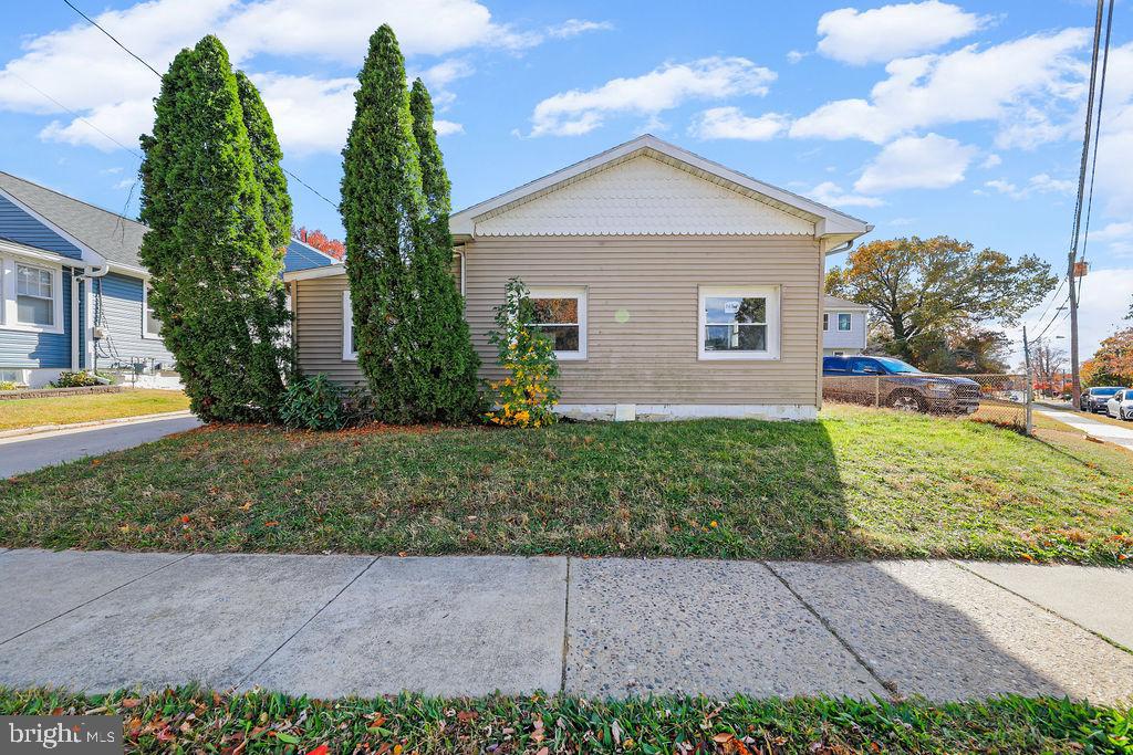 a front view of house with yard and green space