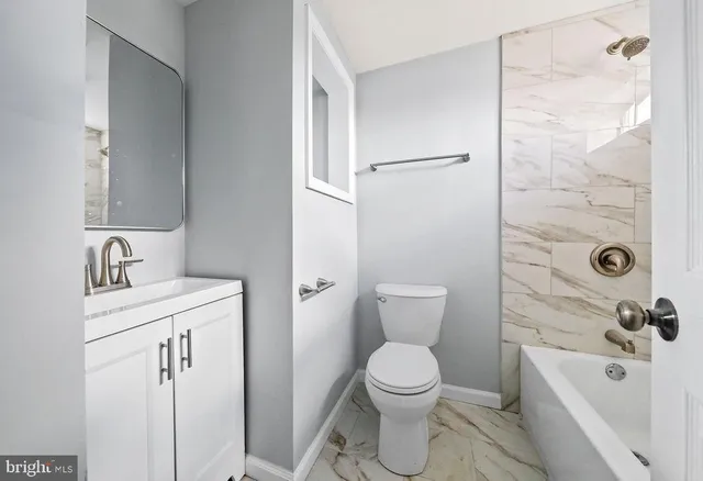 a bathroom with a toilet sink shower and mirror