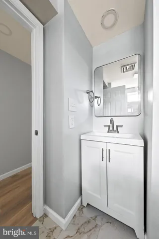 a bathroom with a sink mirror and vanity