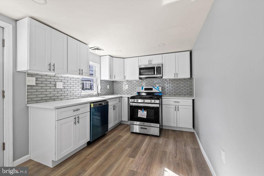 408 West 3rd Avenue Runnemede, NJ 08078 - Photo 2 of 29 a kitchen with granite countertop a sink cabinets stainless steel appliances and a counter space