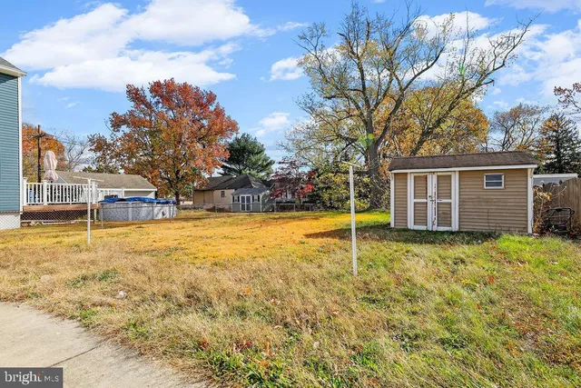 a backyard of a house with large trees