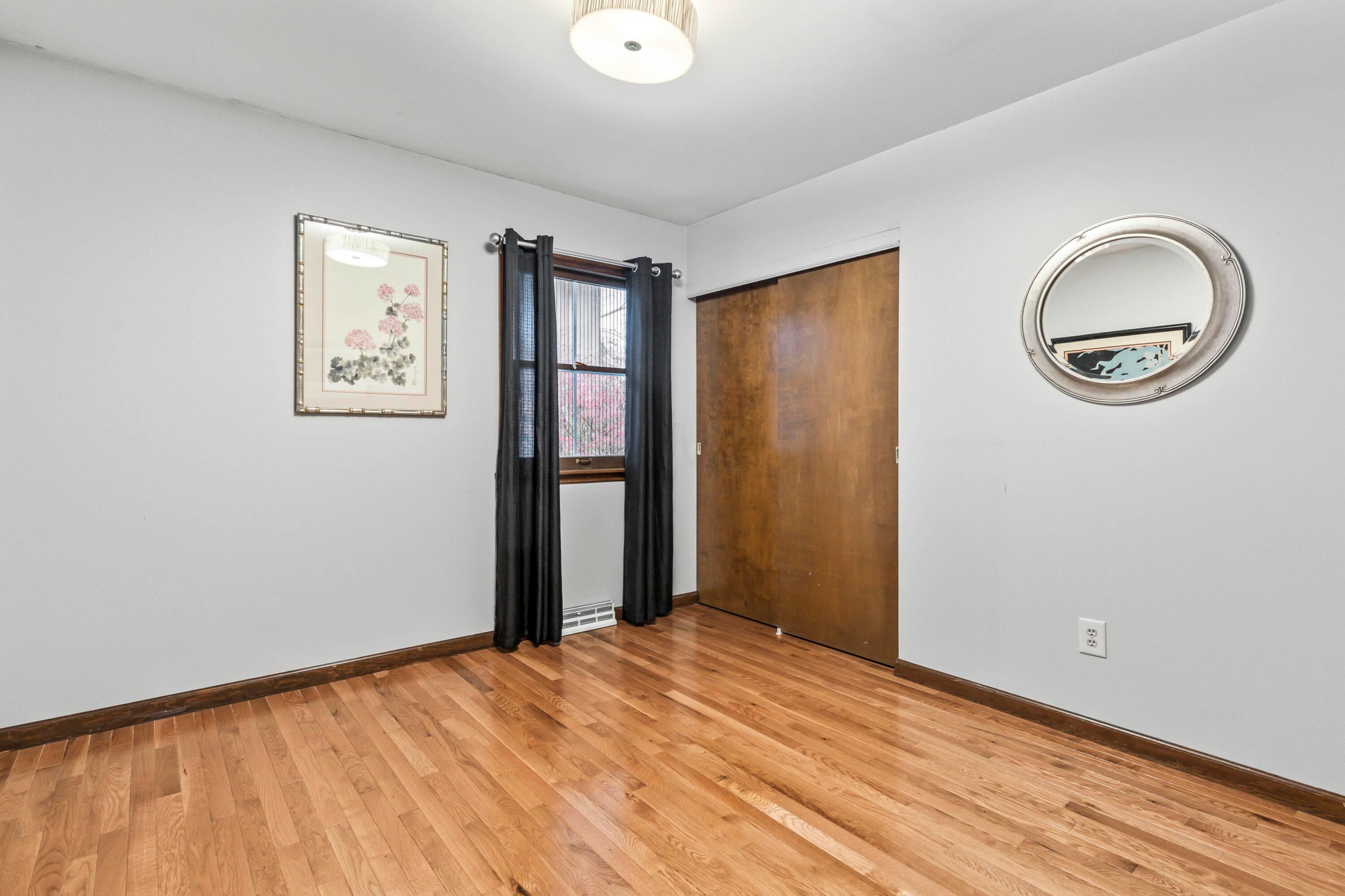 7020 Rieber Street Columbus, OH 43085 - Photo 30 of 40 • New hardwood flooring ~ 2013 • Grey painted walls • New ceiling light ~ 2017 • Drapes are negotiable • Closet with double sliding doors