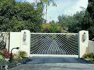 a view of a balcony with plants and wooden fence