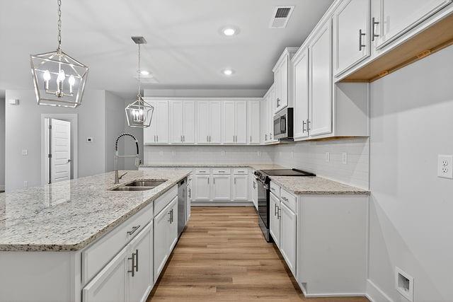 2562 Harbor Ridge Pass Gainesville, GA 30507 - Photo 9 of 27 a kitchen with stainless steel appliances granite countertop a sink stove and cabinets