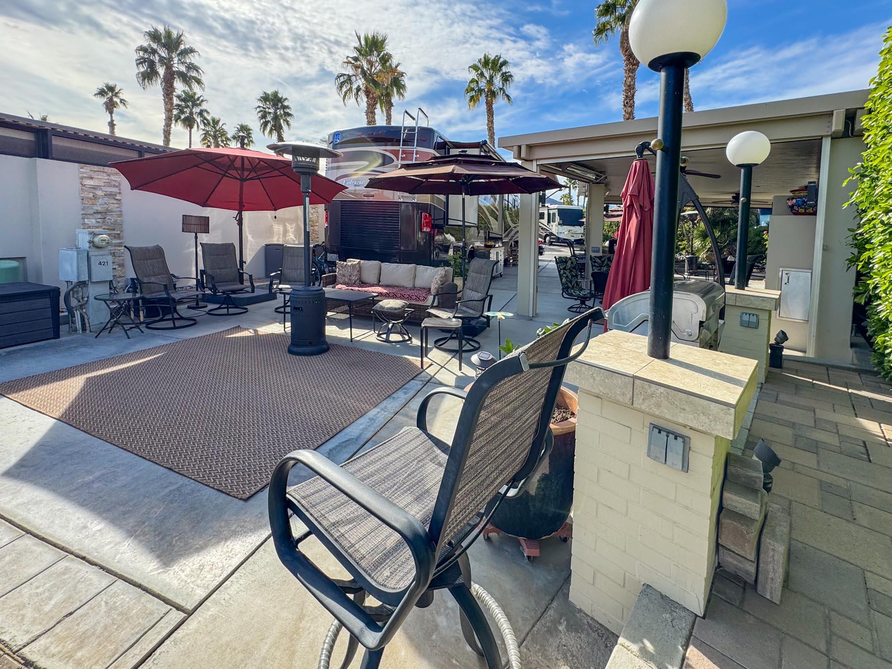 80394 Ave 48, Unit 421 Indio, CA 92201 - Photo 17 of 33 a view of a chairs and tables in patio with a barbeque
