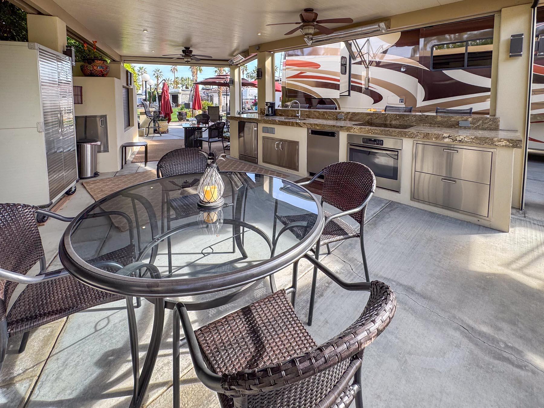 80394 Ave 48, Unit 421 Indio, CA 92201 - Photo 6 of 33 a dining room with furniture a chandelier and wooden floor