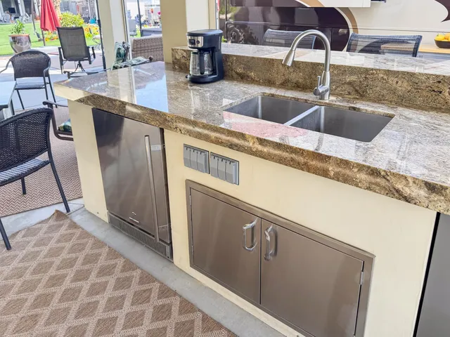 a kitchen with stainless steel appliances granite countertop a sink and a wooden cabinets