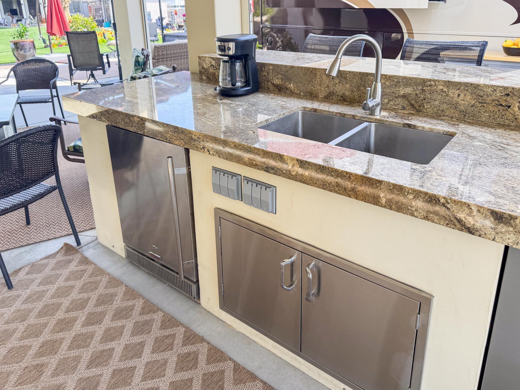 80394 Ave 48, Unit 421 Indio, CA 92201 - Photo 8 of 33 a kitchen with stainless steel appliances granite countertop a sink and a wooden cabinets