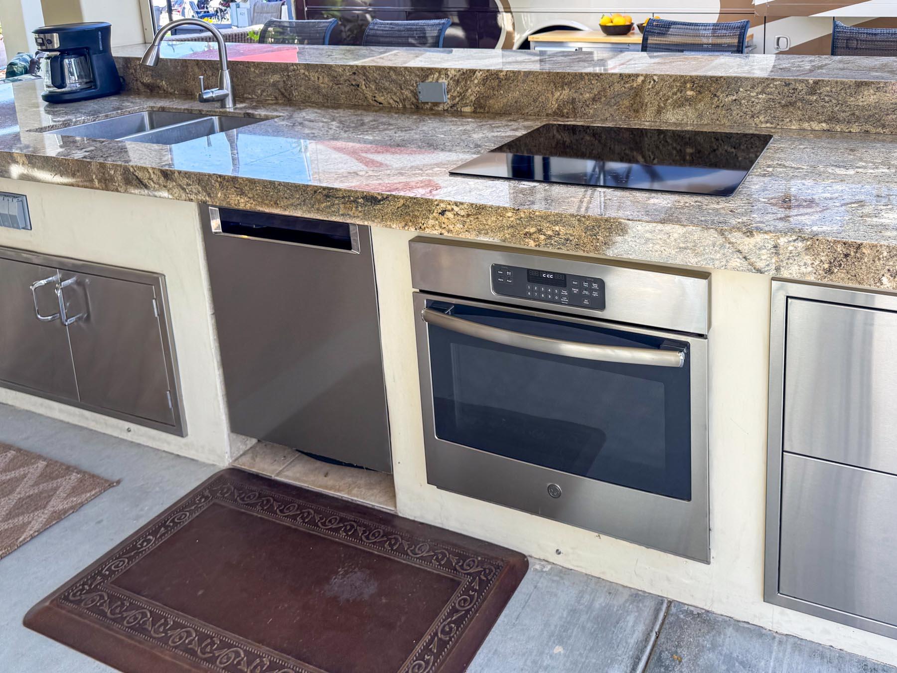 80394 Ave 48, Unit 421 Indio, CA 92201 - Photo 9 of 33 a stove top oven sitting inside of a kitchen