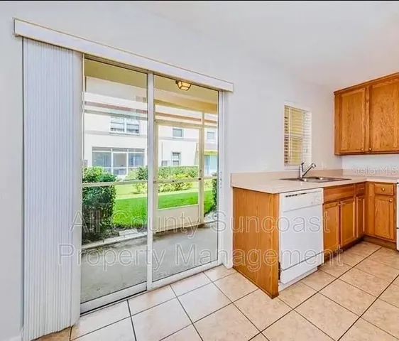 a kitchen with a refrigerator and a sink