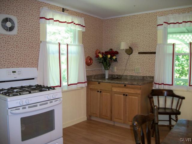 838 Pheasant Run Road Effort, PA 18330 - Photo 11 of 23 a kitchen with stainless steel appliances granite countertop a stove a sink and a refrigerator
