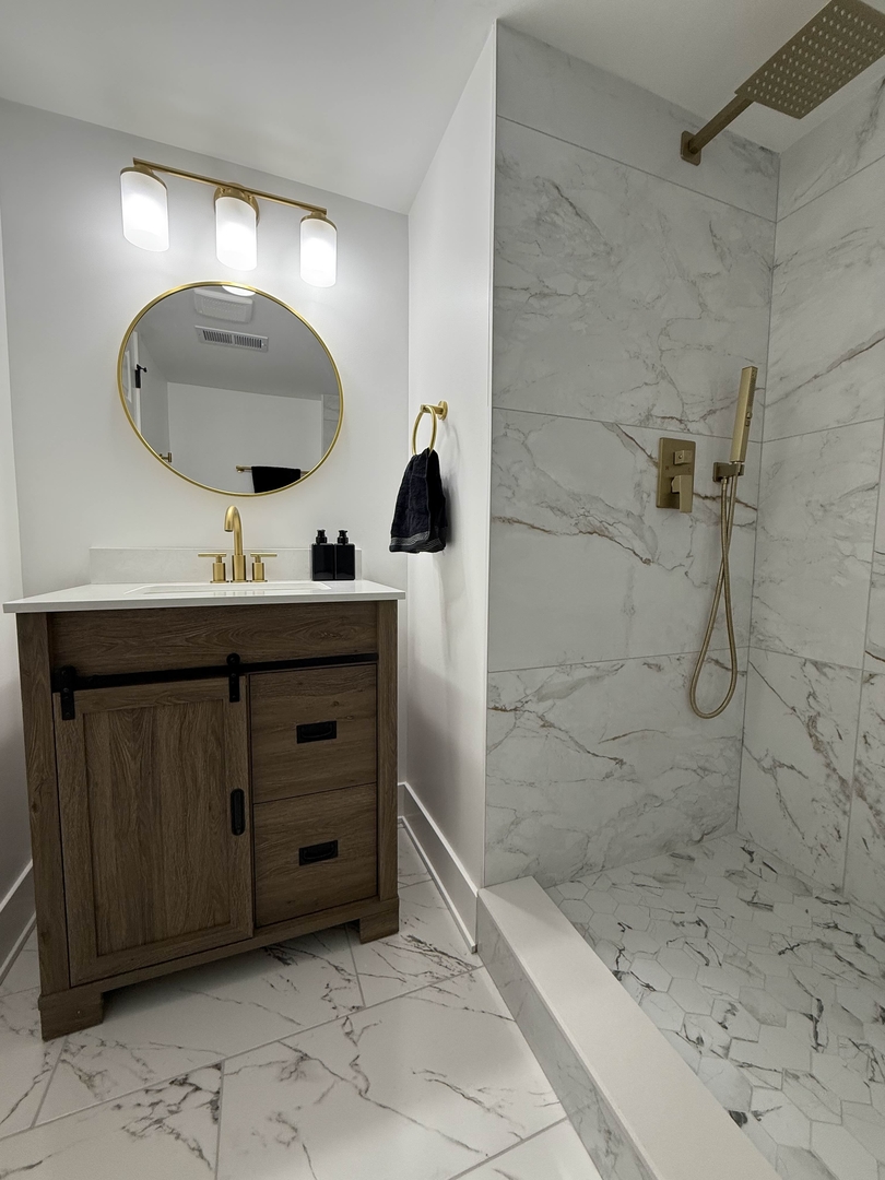 6230 West 63rd Place Chicago, IL 60638 - Photo 11 of 17 a bathroom with a sink a toilet and mirror