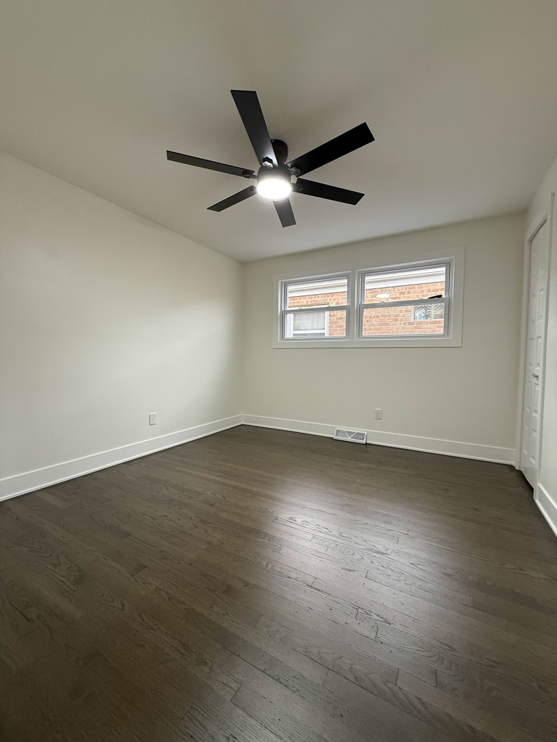 6230 West 63rd Place Chicago, IL 60638 - Photo 9 of 17 an empty room with wooden floor and windows