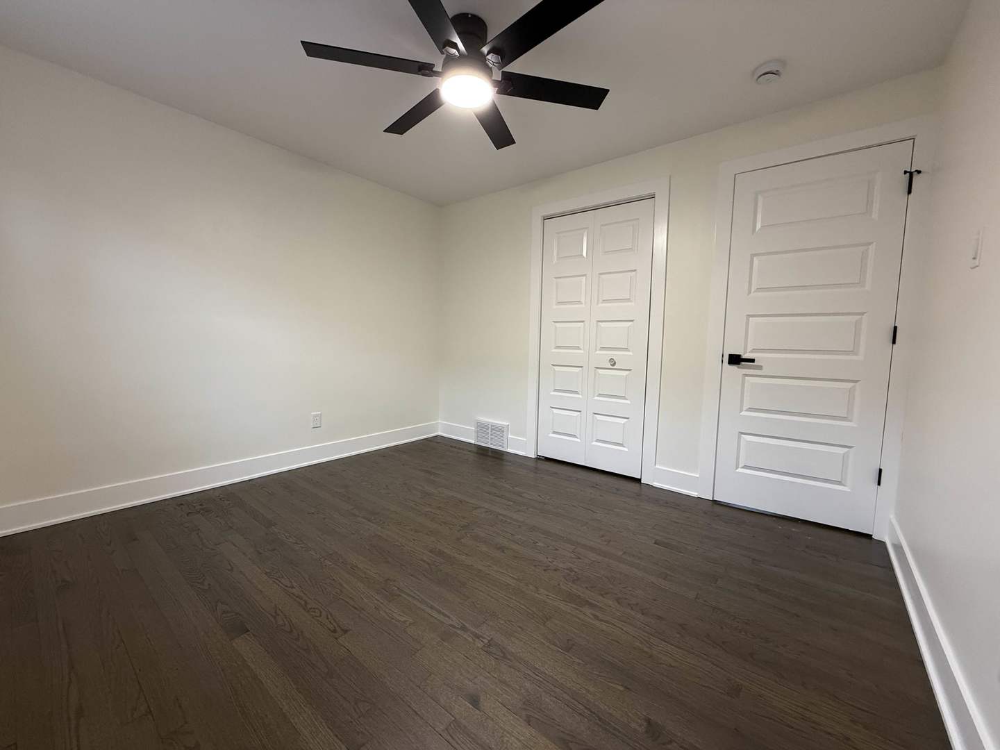 6230 West 63rd Place Chicago, IL 60638 - Photo 10 of 17 an empty room with wooden floor closet ceiling fan and windows