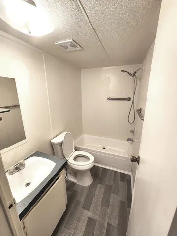 a white toilet sitting next to a bathroom sink
