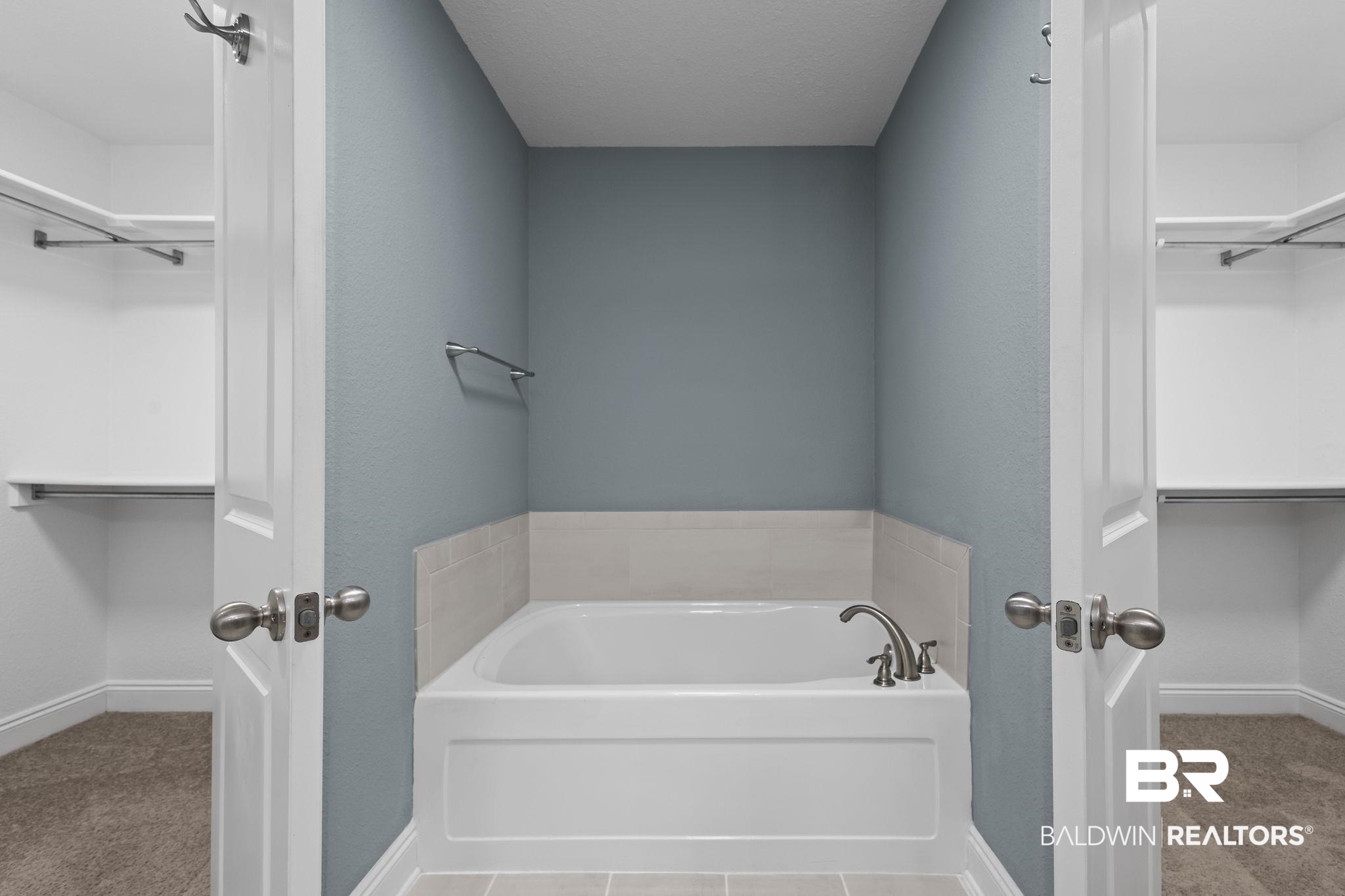 8781 Baptist Camp Road Elberta, AL 36530 - Photo 9 of 44 Full bathroom featuring a garden tub, a walk in closet, and baseboards