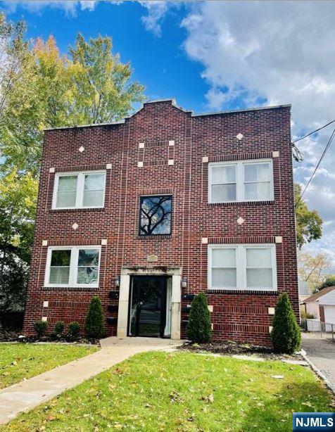 229 Orient Way, Unit 6 Rutherford, NJ 07070 - Photo 1 of 8 a front view of a house with a yard
