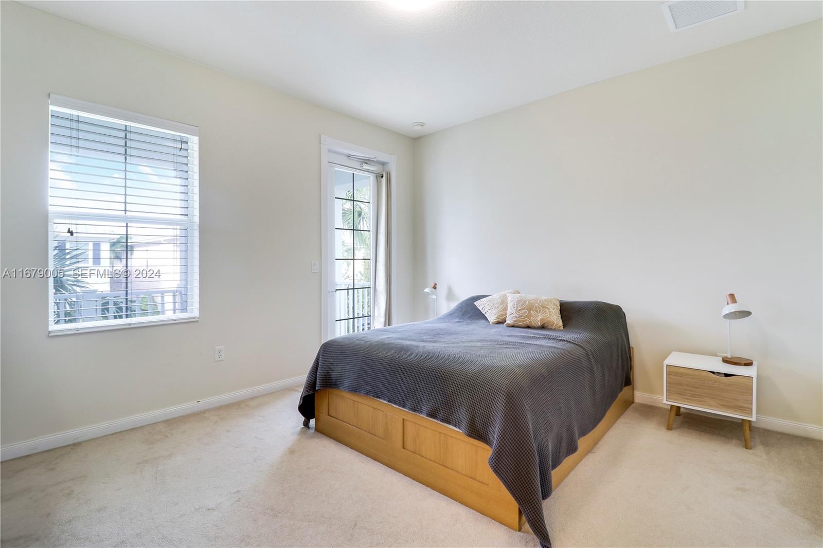 1184 Islamorada Drive, Unit 1184 Jupiter, FL 33458 - Photo 19 of 34 a bedroom with a bed and window