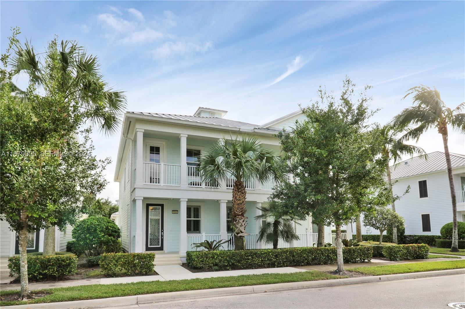 1184 Islamorada Drive, Unit 1184 Jupiter, FL 33458 - Photo 2 of 34 a front view of a house with a yard and garage