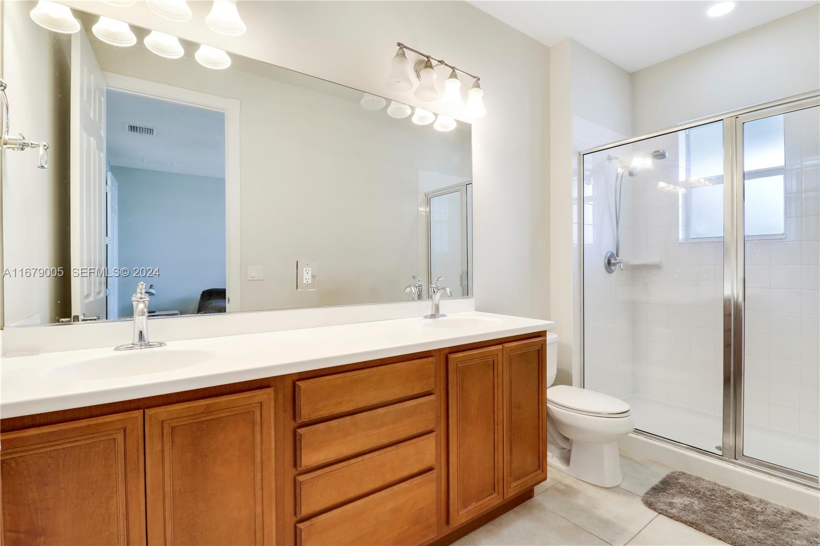 1184 Islamorada Drive, Unit 1184 Jupiter, FL 33458 - Photo 21 of 34 a bathroom with a sink and a mirror
