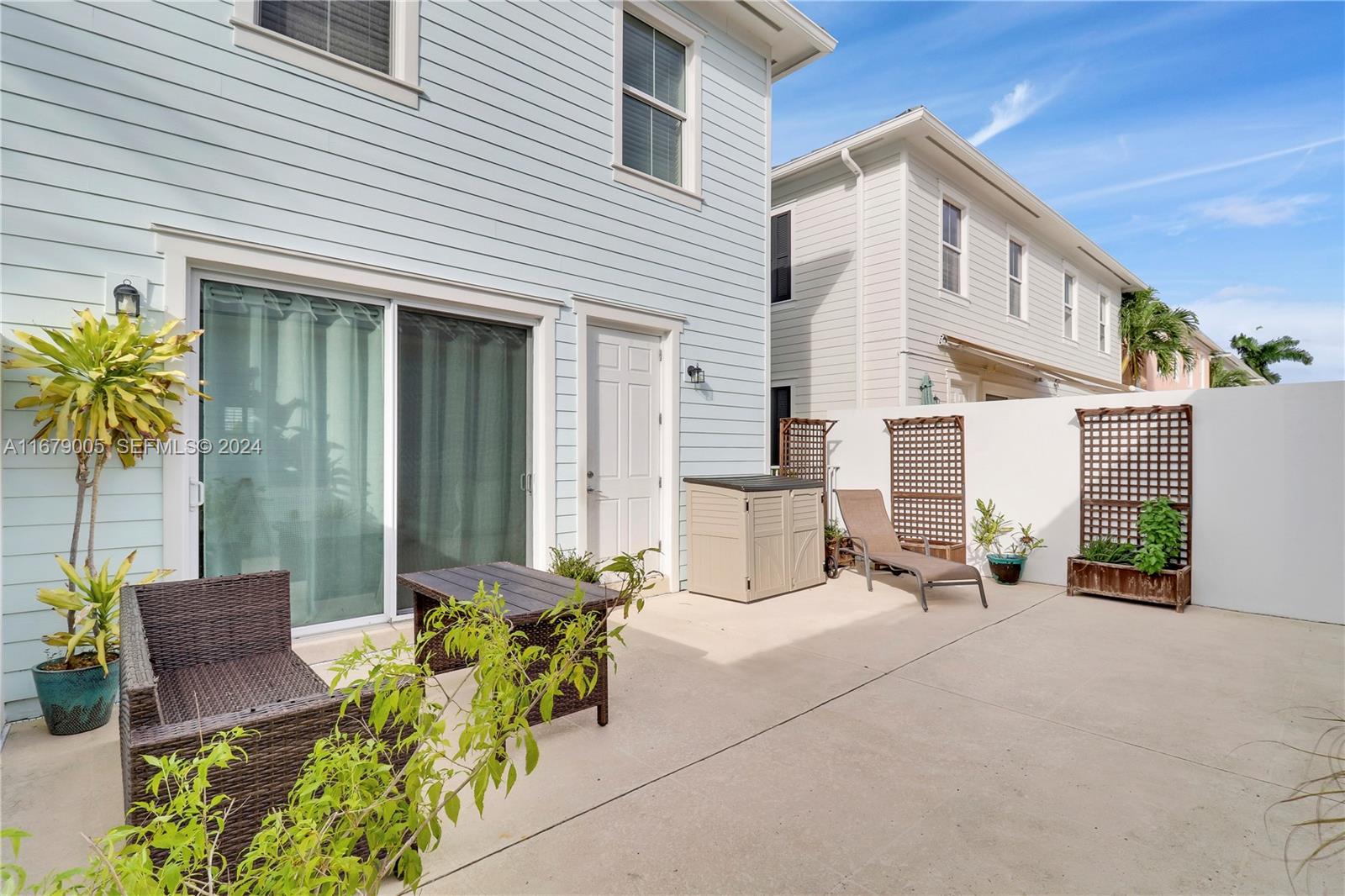 1184 Islamorada Drive, Unit 1184 Jupiter, FL 33458 - Photo 25 of 34 a row of table and chairs in front of house