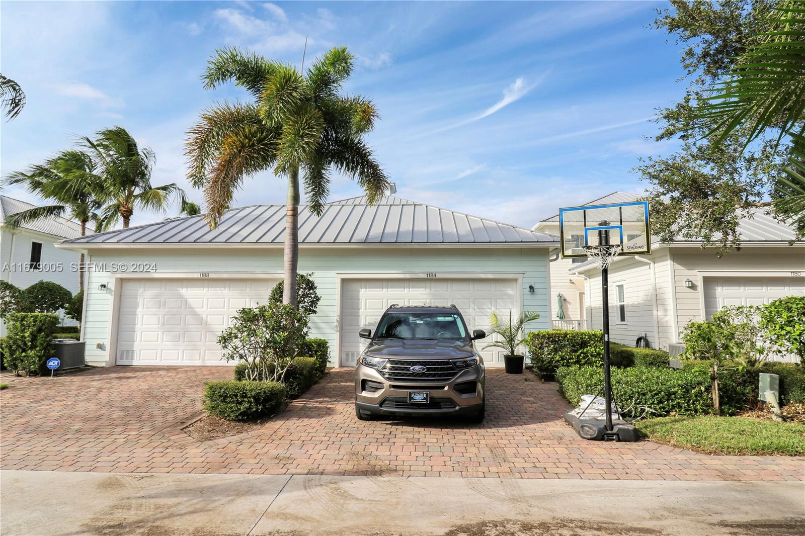 1184 Islamorada Drive, Unit 1184 Jupiter, FL 33458 - Photo 28 of 34 a car parked in front of white house