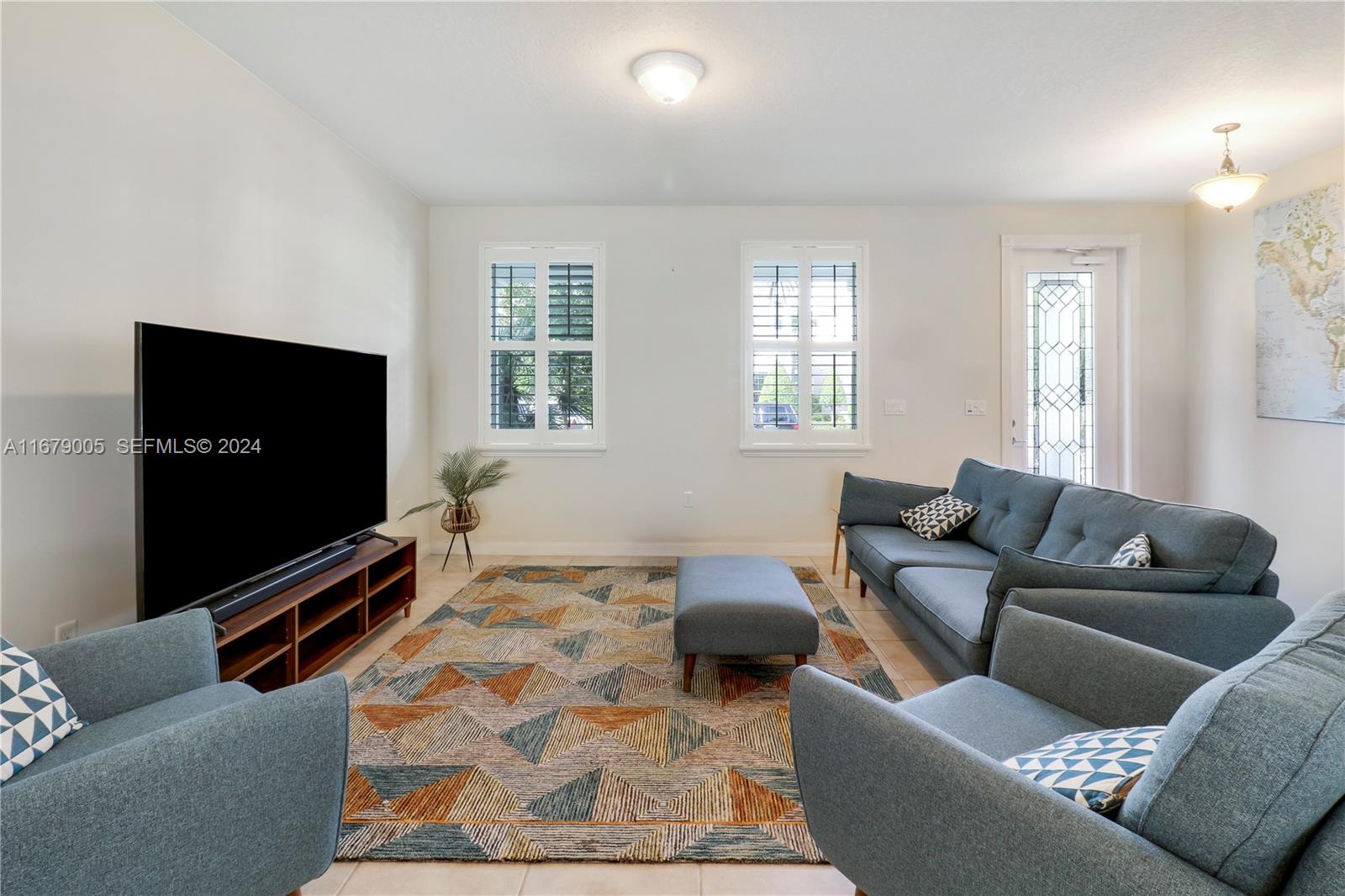 1184 Islamorada Drive, Unit 1184 Jupiter, FL 33458 - Photo 4 of 34 a living room with furniture and a flat screen tv