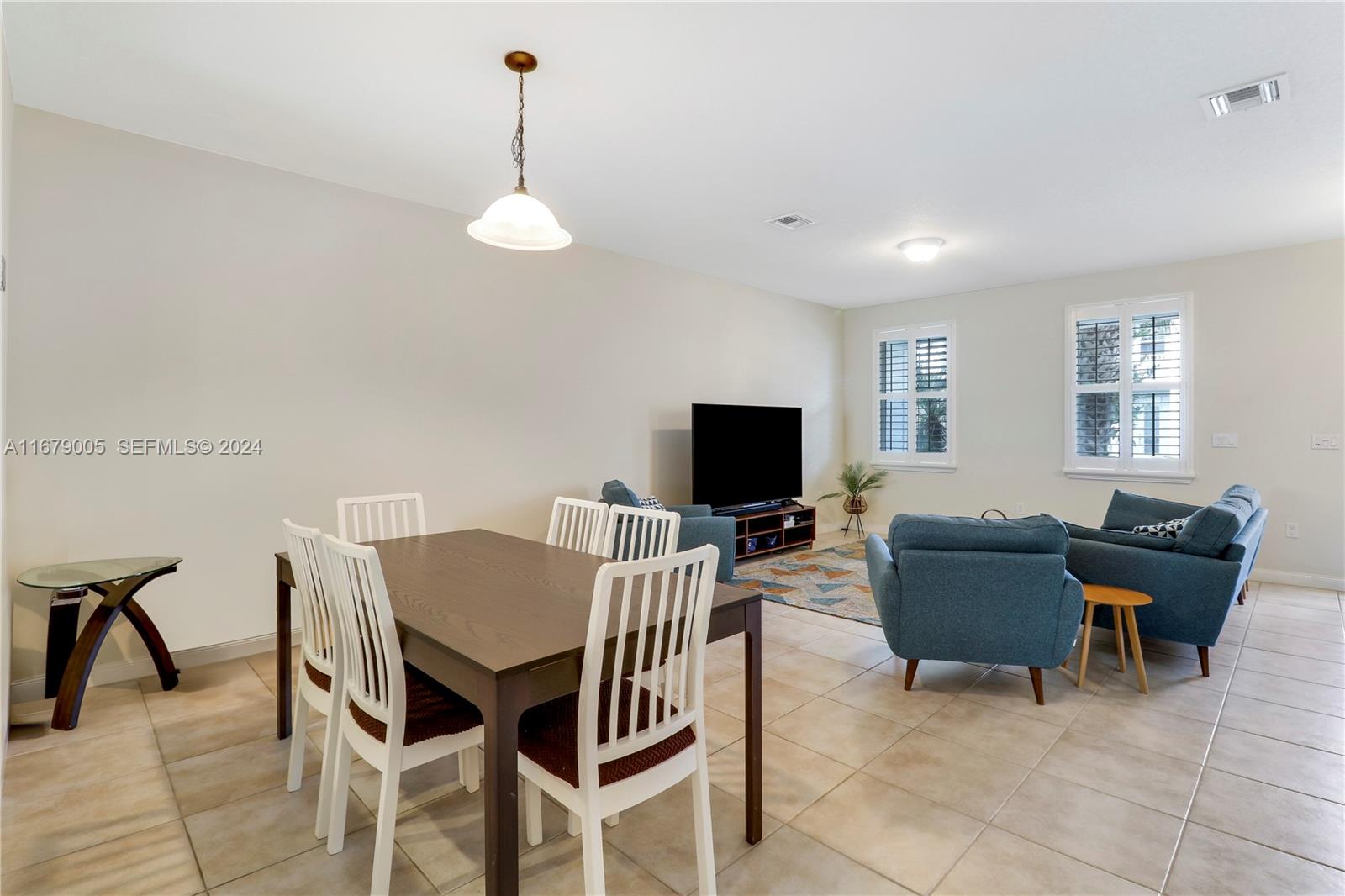 1184 Islamorada Drive, Unit 1184 Jupiter, FL 33458 - Photo 6 of 34 a view of a livingroom with furniture and a flat screen tv