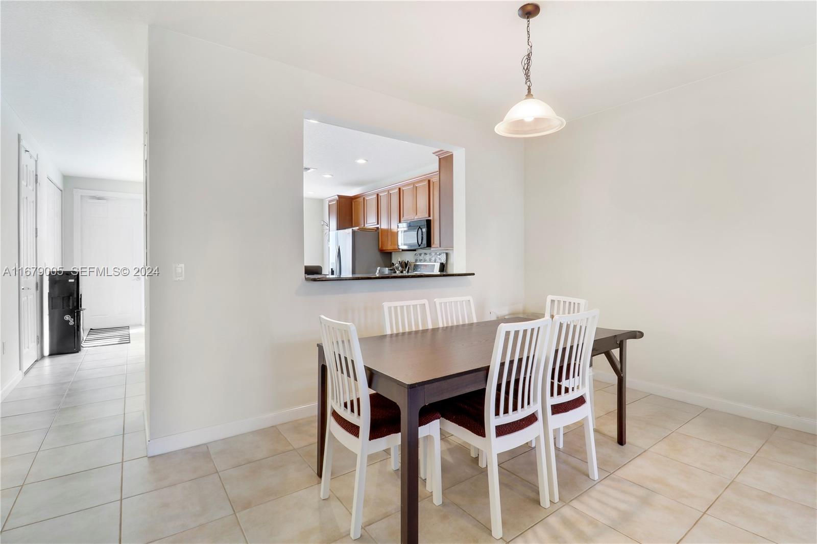 1184 Islamorada Drive, Unit 1184 Jupiter, FL 33458 - Photo 8 of 34 a view of a dining room with furniture and wooden floor