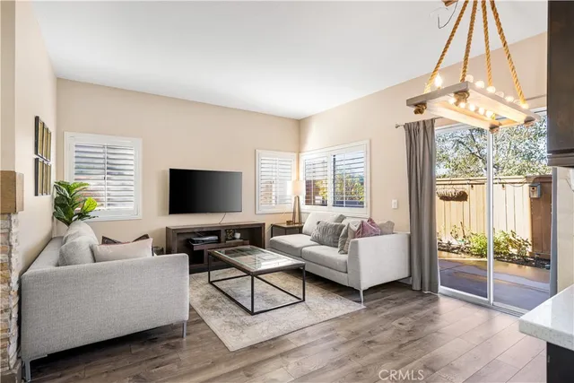 a living room with furniture a large window and a flat screen tv