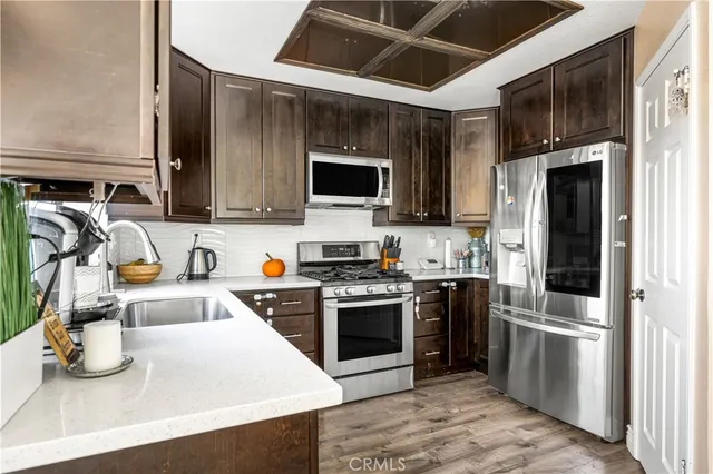 a kitchen with stainless steel appliances a stove a sink and a microwave