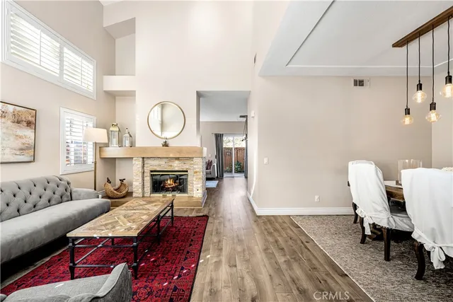 a living room with furniture a fireplace and a table