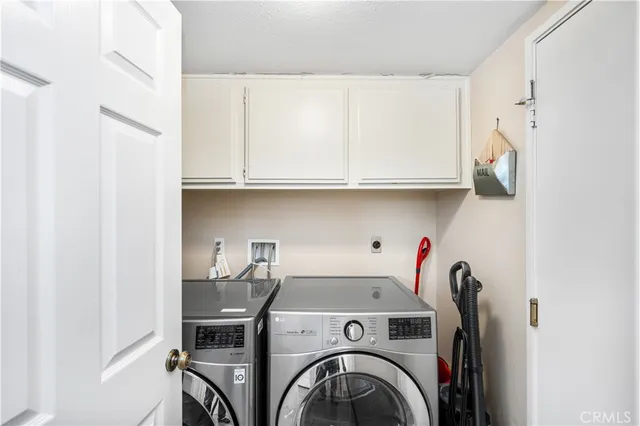 a view of storage and utility room with washer and dryer
