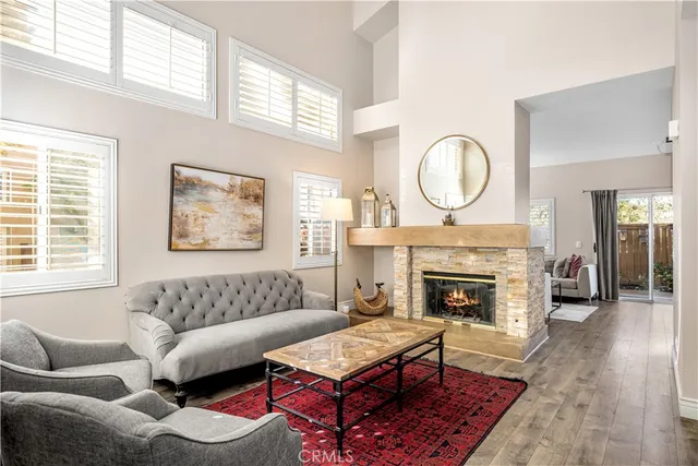 a living room with furniture a fireplace and window