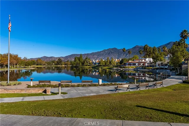 a view of a lake with couches chairs