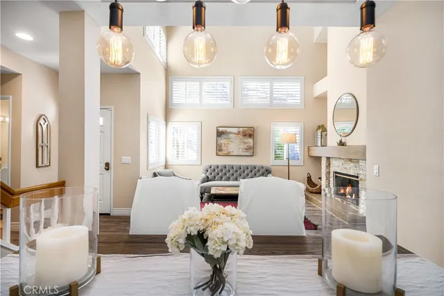 a living room with furniture a fireplace and large windows